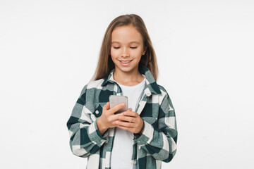 Young caucasian preteen teenage girl schoolgirl daughter using cellphone online for e-learning, social media, online video games isolated in white background