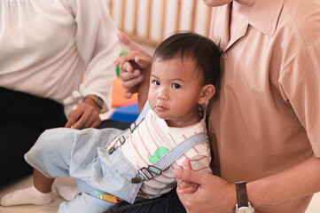 Happy Infant boy with father and mother smiling	