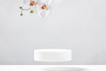 Flying empty white podium and white orchid flowers on white background. Mock up stand for product presentation. 3D Render. Minimal concept.