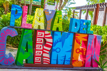 Colorful Playa del Carmen lettering sign symbol on beach Mexico.