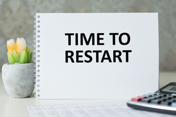 Time to Restart text on a notepad on an office desk