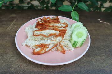 rice topped with chicken or chicken rice or fried chicken and rice