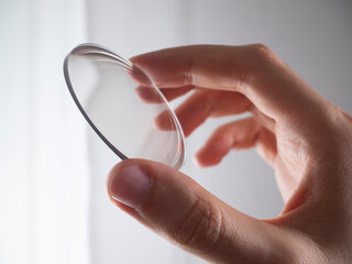 Fototapeta hand holding lens for eyeglass modern manufacturing in laboratory obraz