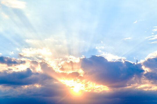 Rays Of Evening Sun In Dark Blue Clouds