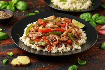 Stir fry pepper chicken with sweet peppers, onion, garlic and ginger