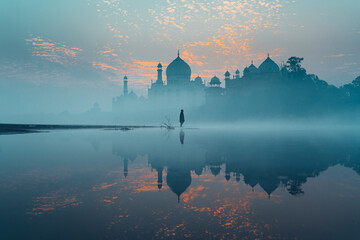Taj mahal reflection view from back side on a winter morning, foggy and pink clouds sunrise.