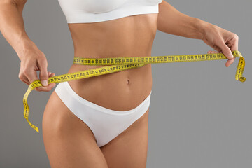 Closeup Shot Of Young Woman With Measuring Tape Checking Waist Size