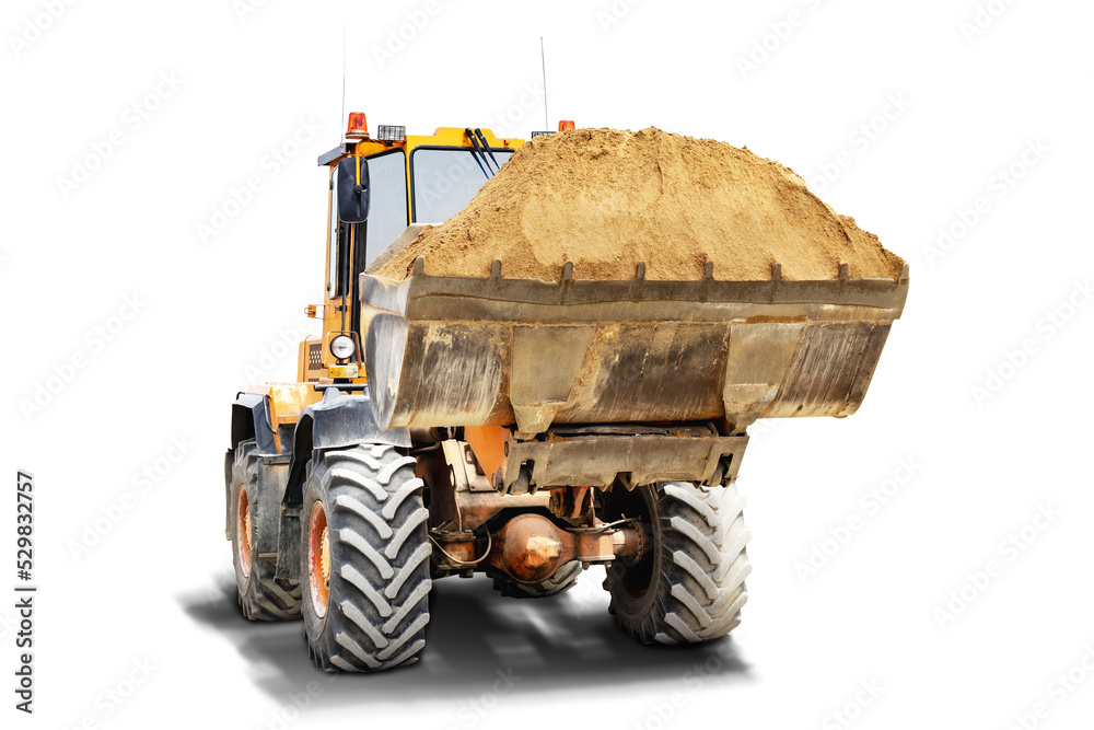 Wall mural a large front loader transports sand in a bucket at a construction site. transportation of bulk mate