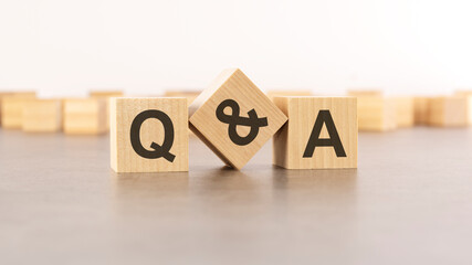 text Q and A is made of wooden blocks on gray background