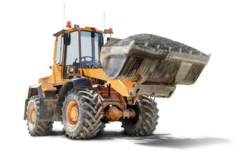 A large front loader transports crushed stone or gravel in a bucket at a construction site....