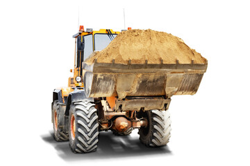 A large front loader transports sand in a bucket at a construction site. Transportation of bulk materials. Isolated loader on a white background. - obrazy, fototapety, plakaty