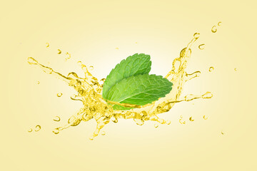 Mint oil splash with fresh spearmint leaf isolated on yellow background.