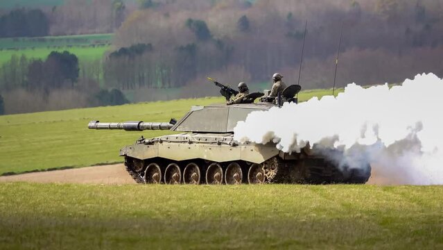 British army Challenger 2 ii FV4034 main battle tank in action, throwing out a white smoke screen for cover