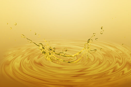 Cooking Oil Or Essential Oil Splash With Gold Color Background. 