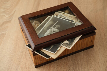 close-up old vintage photos 50s, 60s sepia color in brown wooden box, chest, concept of antique...