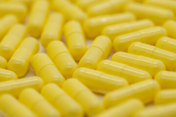 Many yellow pills distributed, medicine, cropped image