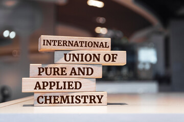 Wooden blocks with words 'International Union of Pure and Applied Chemistry'.