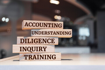 Fototapeta premium Wooden blocks with words 'Accounting, Understanding, Diligence, Inquiry, Training'.