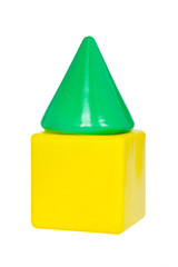 A green cone on a yellow cube from a children`s toy set stacked into a piramid. Children`s construction game. Developmental creativity