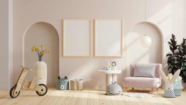 Mockup frame in the children's room with pink armchair on cream color wall.