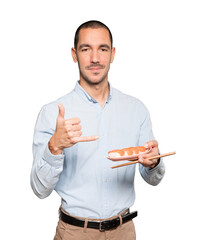 Young man using chopsticks to eat sushi