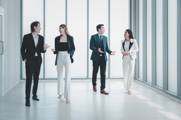 Fototapeta premium Group business people in formal wear walking standing discussion in modern office