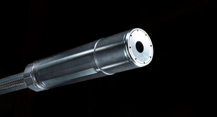 Suppressor on a gun barrel with black background