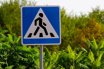 Pedestrian triangle road sign blue background