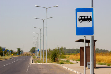 Bus stop sign on the blue background near bus station