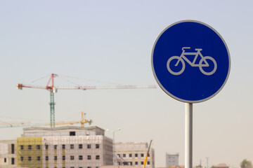 Bicycle sign with Construction crane on the background