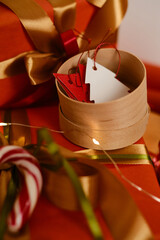 Packing Christmas and New Year gifts. Packing material, Christmas toys, sweet cane, ribbons and Christmas lights. Flat lay top view. Place for text. Happy Holidays!