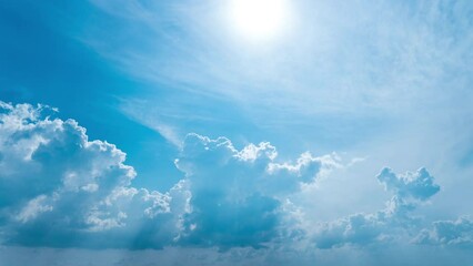 White fluffy clouds slowly float through the blue daytime sky timelapse. Beautiful skies are moving. Airy snow-white clouds move to the side.