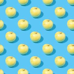 Seamless pattern of green apples on a blue background