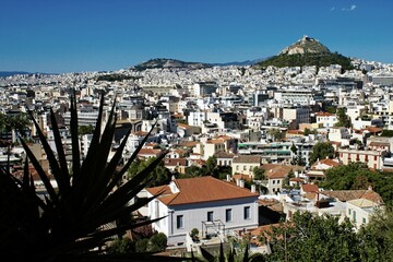 Athens city view from the area of Anafiotika in Plaka district with Lycabetus hill in the background.