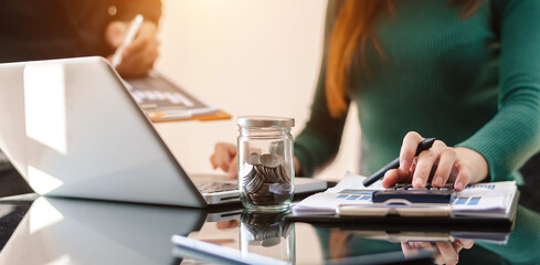 The business team analyzes revenue charts and graphs with laptop and tablet.Business analysis and strategic ideas..