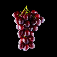 Shiny bunch of ripe backlit grapes isolated on black background