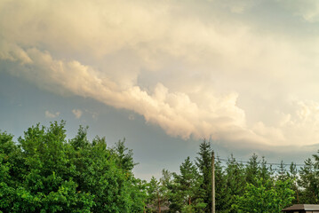 Fototapeta premium Close up view of beautiful colored dramatic cumulus fluffy clouds on blue sky at sunset background