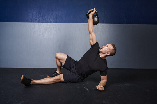 man performs a kettlebell Turkish get up