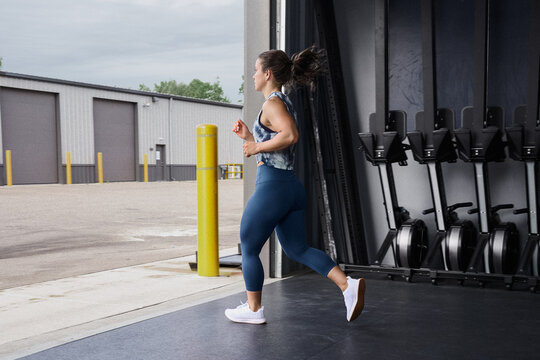 Woman Running Out Of Gym