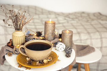Cozy autumn composition with a cup of tea and decorative details.