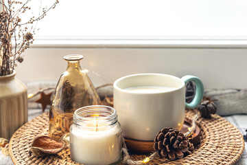 Cozy home composition with coffee cup and home decor details.