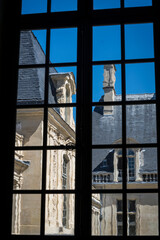 Detail of a house seen through a window,  in sunshine, located in the Marais district, Paris, France