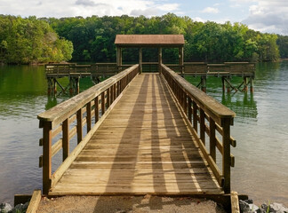 Fototapeta premium Empty fishing pier on mountain lake.