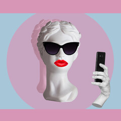 Female antique statue's head with red lips wearing black sunglasses takes selfie with mobile phone on color background. 3d trendy collage in magazine style. Contemporary art. Modern design