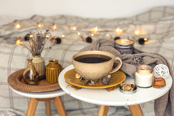 Cozy autumn composition with a cup of tea and decorative details.