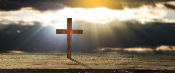Christian cross on wooden floor