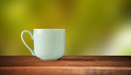 Cup with coffee on the table on nature background