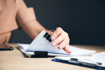 Fototapeta premium woman hands working in Stacks paper files
