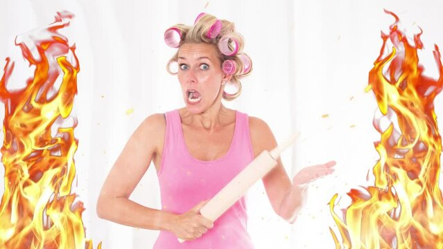 Cinemagraph of screaming woman with hair curlers holding a rolling pin and flames around her
