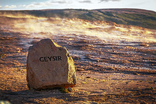 Stunning Nature of Iceland. Amazing area near Strokkur Geysir under sunlight. Stone sign in front of Geysir in the Haukadalur valley Incredible nature landscape. Iceland- most popular place of travel.